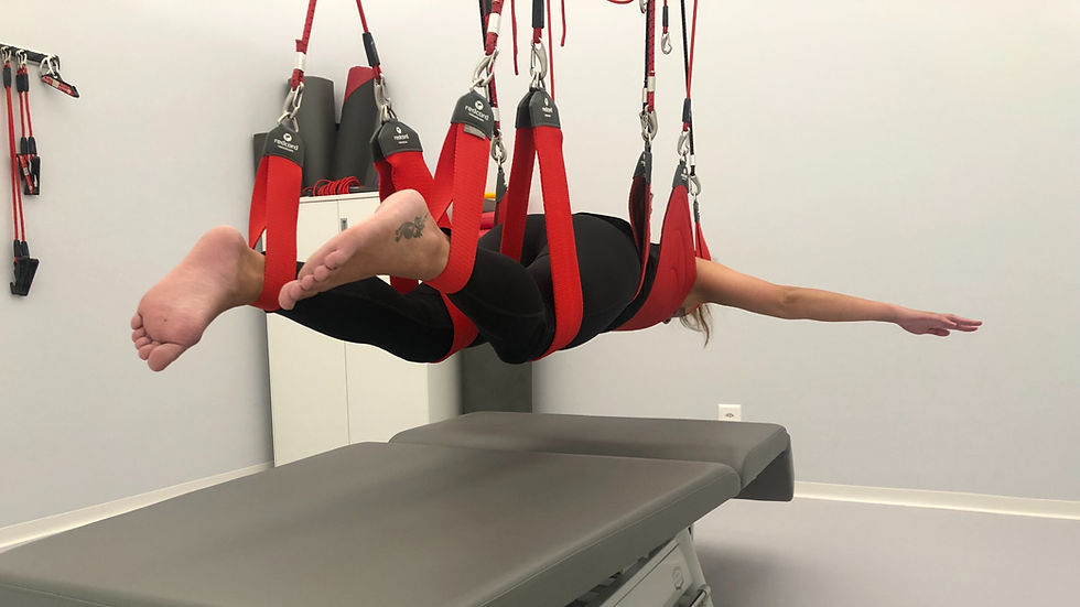Joanna performing a Neurac treatment using Redcord suspension therapy at Chenot Palace Weggis, designed to improve neuromuscular control and relieve pain.