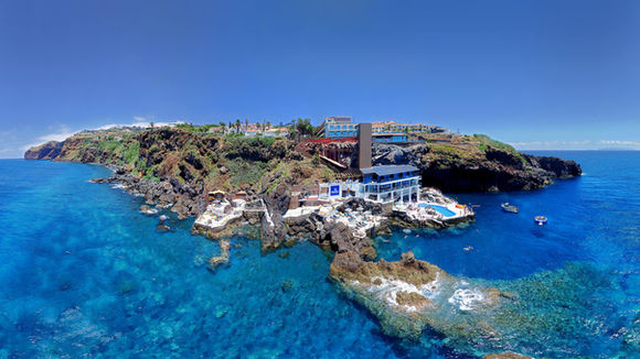 Aerial view of Galo Resort on the Madeira coastline with turquoise ocean