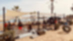 Outdoor beach fitness area at Boot Camp Marbella, Spain, with participants lifting weights.