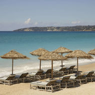 Beach with sun loungers and umbrellas at F Zeen Retreats Kefalonia, Greece