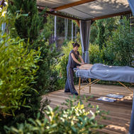 Outdoor massage at Euphoria Retreat under a curtained pergola