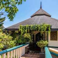 Entrance to the Ayurveda spa building surrounded by lush greenery at Mangosteen Resort