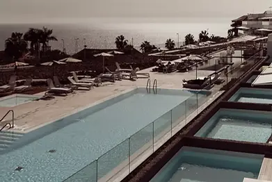 Poolside view with mountain backdrop at Baobab Suites Tenerife