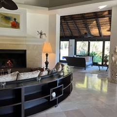 Cosy indoor lounge with sofas and fireplace, offering a quiet place to relax at Shanti Som.