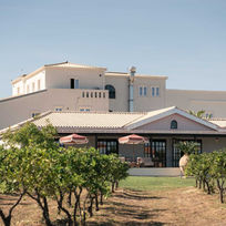 Restored 19th-century farmhouse at Shanti-Som Algarve, seen across the orange orchard