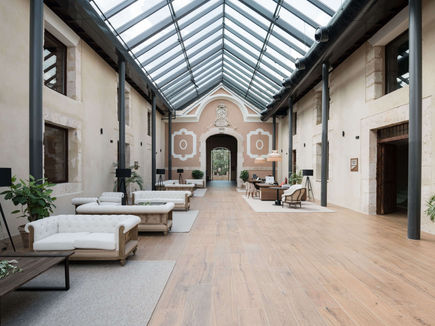 Atrium lounge area with glass roof at Castilla Termal Brihuega