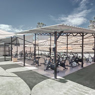 Shaded outdoor training area with spin bikes and weights at Domes Baobab Suites