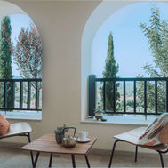 Guest room veranda at Euphoria Retreat looking out over cypress trees to the valley