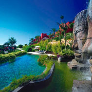 Pond with waterfall and tropical landscaping at Asia Gardens Hotel & Thai Spa