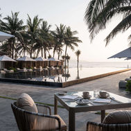 Poolside seating at TIA Wellness Resort overlooking My Khe Beach and the sea