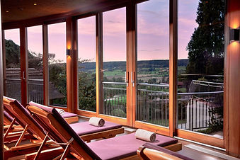 Relaxation room at Ayurveda Resort Mandira with panoramic countryside views.