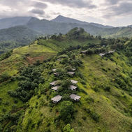 Santani's chalets scattered along a green hilltop ridge