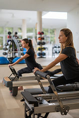 Women practising reformer Pilates at Palasiet Wellness Clinic gym