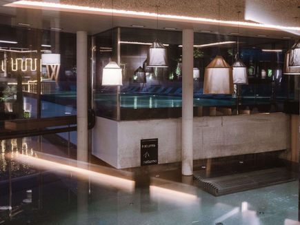 Evening ambience at the indoor pool area with modern lighting at Lindenhof Lifestyle DolceVita Resort in South Tyrol.