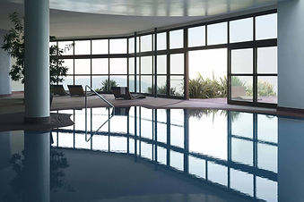 Indoor swimming pool with panoramic lake views at Lefay Resort Lago di Garda