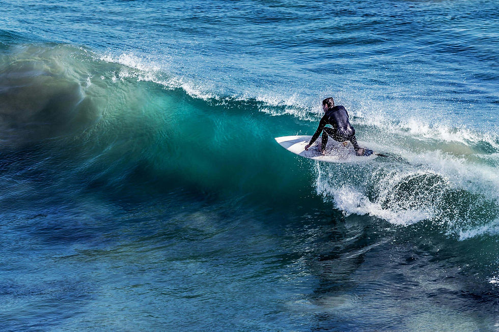 Surfer riding a wave during an active surf and wellness holiday