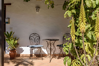 Private shaded patio with wrought iron chairs at Azulfit Yoga and Pilates Retreat