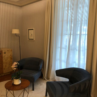 Comfortable seating area in a wellness suite at Chenot Palace Weggis, styled in calming neutral tones.