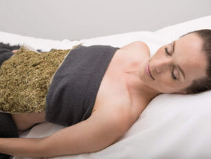 Woman receiving therapeutic herbal compress treatment at Park Igls Austria for digestive wellness and headache relief