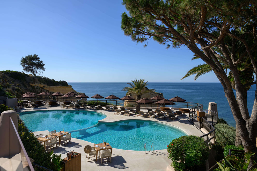 Oceanfront pool at Vilalara Grand Hotel Algarve with sun loungers and panoramic sea views.