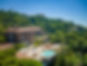 Palasiet Thalasso Clinic & Hotel in Benicàssim, Spain, surrounded by pine-covered hills, featuring a rooftop thalassotherapy pool overlooking the Mediterranean Sea