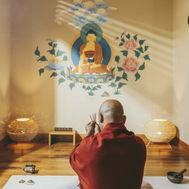 Monk praying in the meditation suite at Six Senses Vana