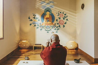 Meditation session led by a monk in a peaceful room at Six Senses Vana wellness retreat.
