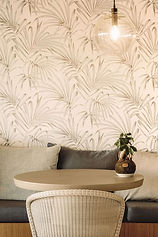 Botanical-themed wall detail and soft furnishings in a calm relaxation area