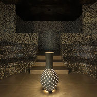 Luxurious hammam with mosaic tile walls and ambient lighting
