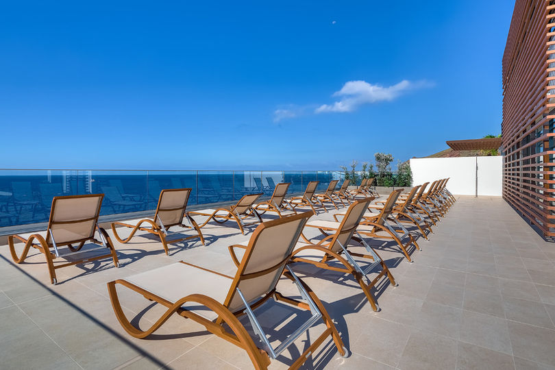 Sundeck with loungers overlooking the Atlantic Ocean at Galo Resort Madeira