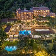 Palasiet Thalasso Clinic illuminated at night, nestled in the Spanish hillside.