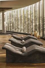 Curved spa loungers and candles in tranquil hydrotherapy zone at SHA Wellness Mexico