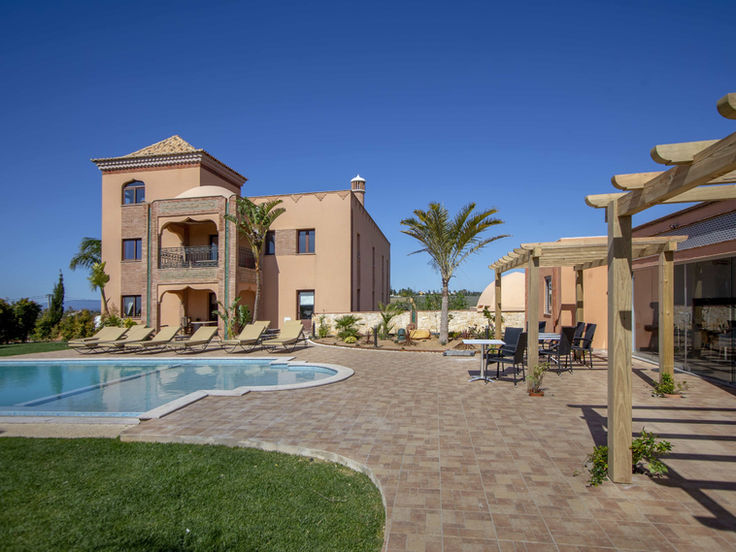 Poolside view of Al Karob Yoga Retreat set within peaceful Portuguese countryside