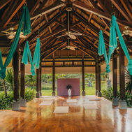 Aerial yoga pavilion at Shanti Maurice with silk hammocks beneath a timber roof