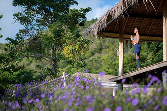 Woman practising yoga in an open-air hillside pavilion at Absolute Sanctuary, Koh Samui