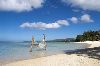 Seaside hammock over turquoise waters at Shanti Maurice beach Mauritius