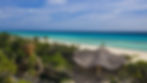 Sculpture garden and white-sand beach at Palmaïa – The House of AïA in Playa del Carmen, Mexico, with turquoise Caribbean Sea.