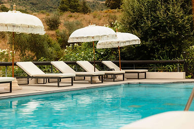 Relaxing poolside loungers and parasols at Shanti Som retreat