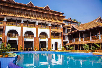 Traditional Kerala-style architecture with swimming pool at Ayursoma Ayurveda Resort.