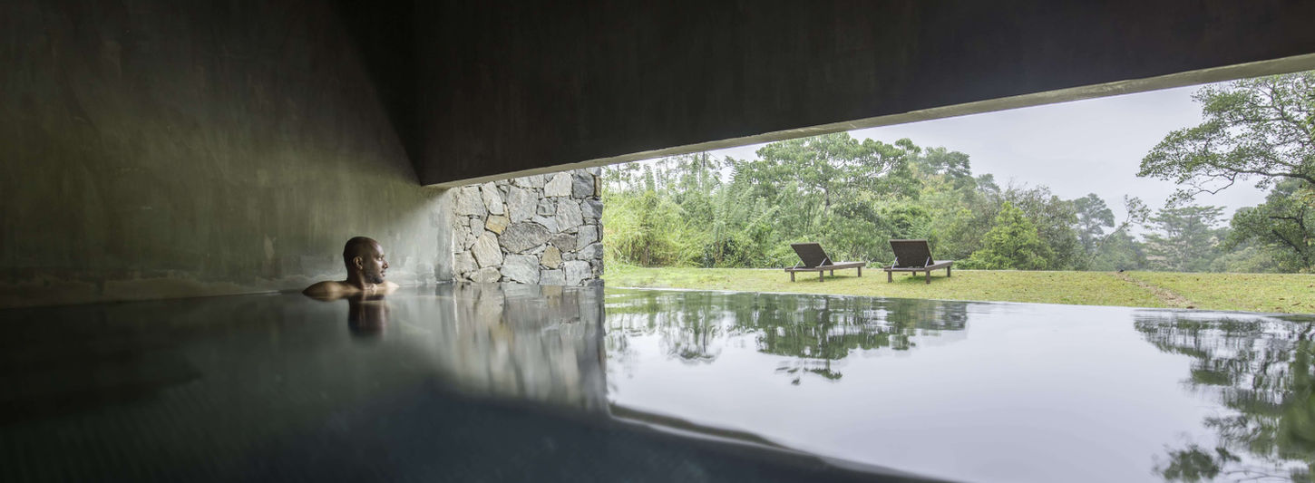 Tranquil indoor pool and relaxation area at Santani Wellness Resort