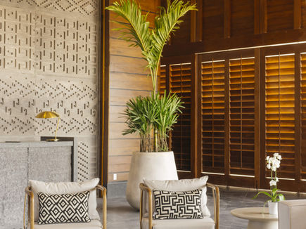 Lounge seating at SHA Wellness Clinic Mexico with carved timber screens and patterned wall panels