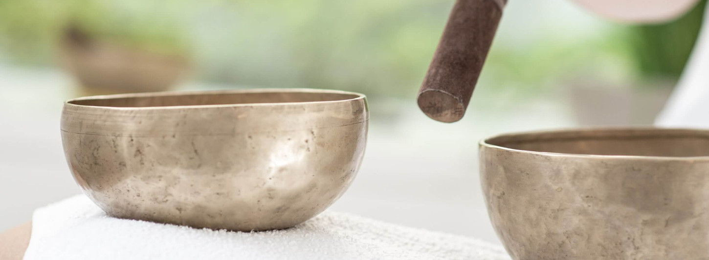 Sound healing therapy setup with Tibetan singing bowls at Clinique La Prairie