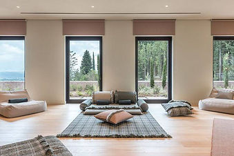 Minimalist indoor meditation lounge with forest views at Euphoria Retreat