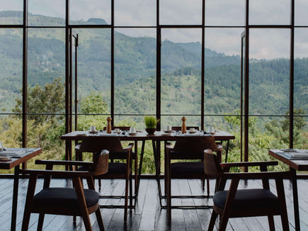 Restaurant table set beside floor-to-ceiling windows at Santani