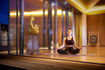 Woman meditating in studio at Ayurveda Resort Mandira