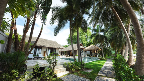 Tropical garden villas surrounded by palm trees at Samahita Retreat