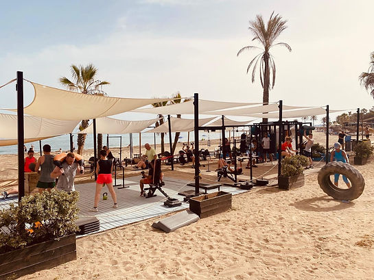 Beachfront fitness training area with group workout at Boot Camp Marbella in Spain