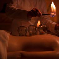 Fire cupping treatment in low-light therapy room at Zulal Wellness Resort
