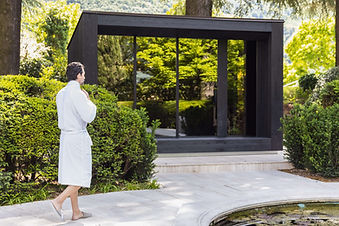 Guest walking to wellness pavilion in lush gardens at Villa Eden