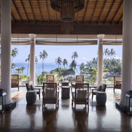 Open-air tea lounge with panoramic views of palm trees and the ocean at Anantara Peace Haven Tangalle